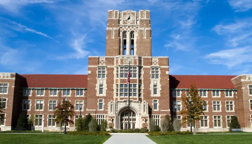 Iconic Ayres Hall at the University of Tennessee in Knoxville, a historic red-brick building with a central clock tower and American flag out front