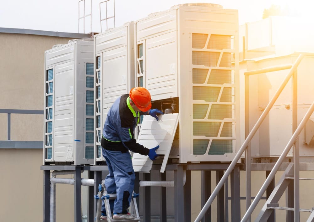 two-people-repairing-industrial-air-conditioner