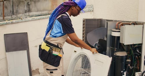 Repairman-working-on-air-conditioner