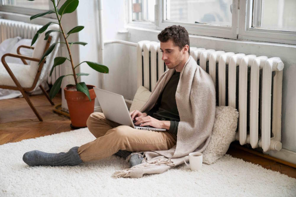 close-up-person-near-heater