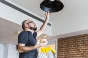 man-changing-light-bulb-min