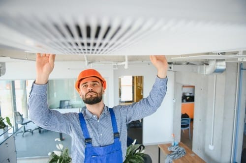 Service technician checking and repairing air condition