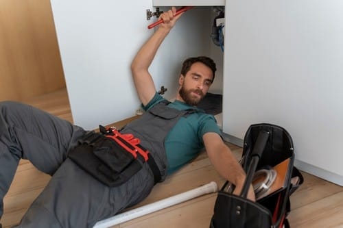high angle man working as plumber